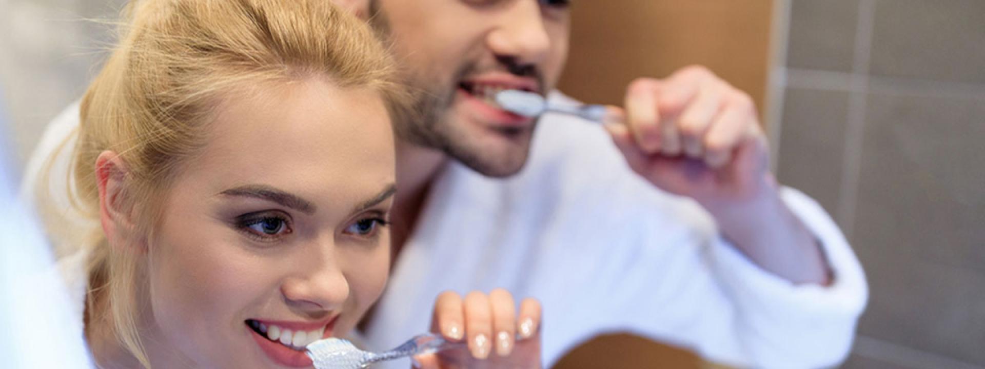 Couple brush their teeth