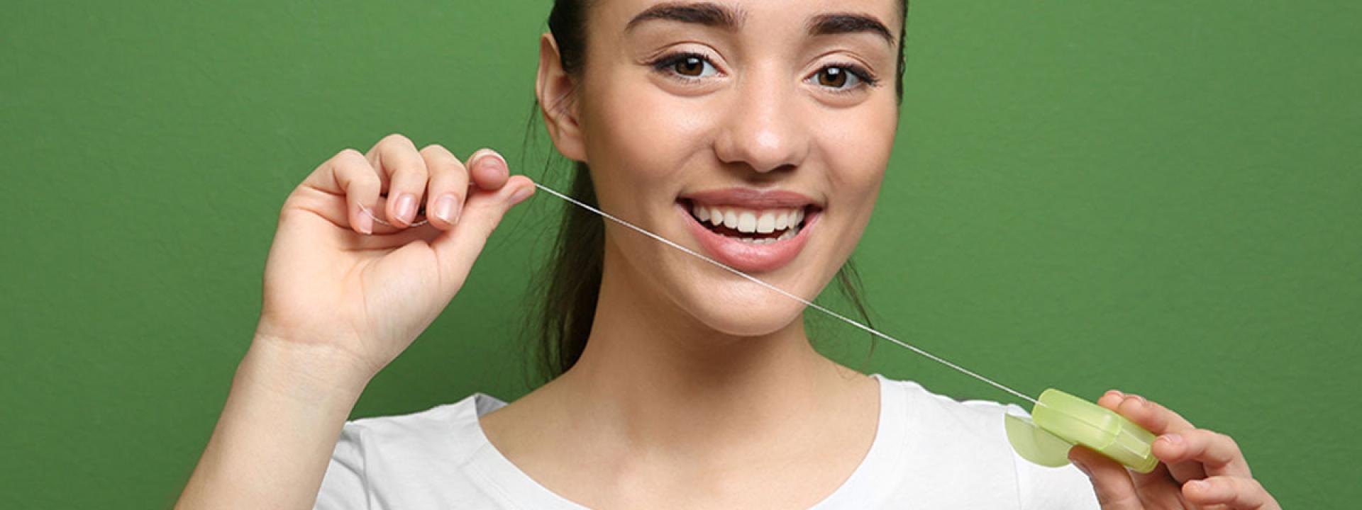 Beautiful woman flossing