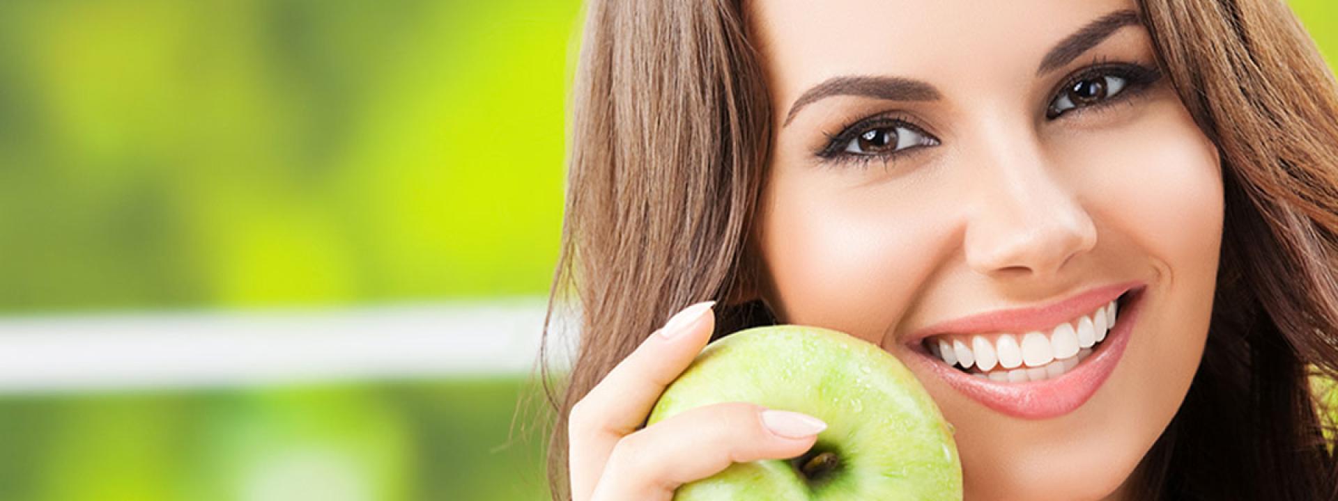 Girl smiling with an apple