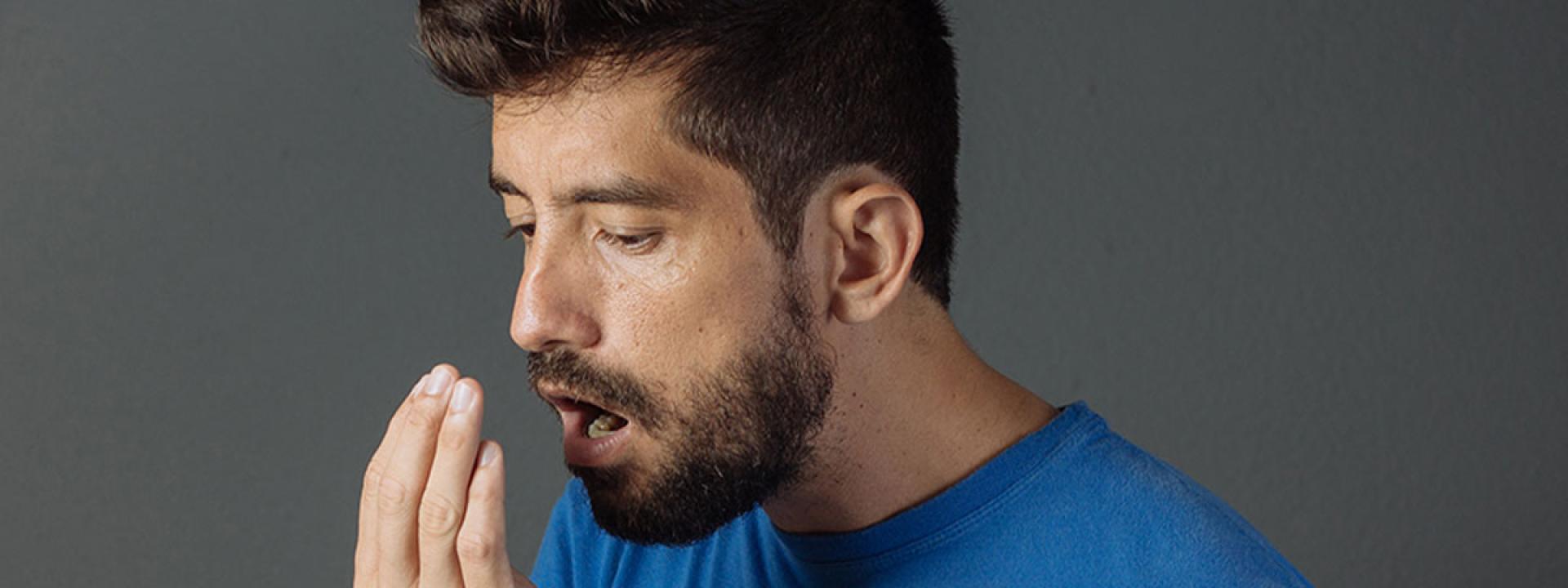 Person check his mouth smell