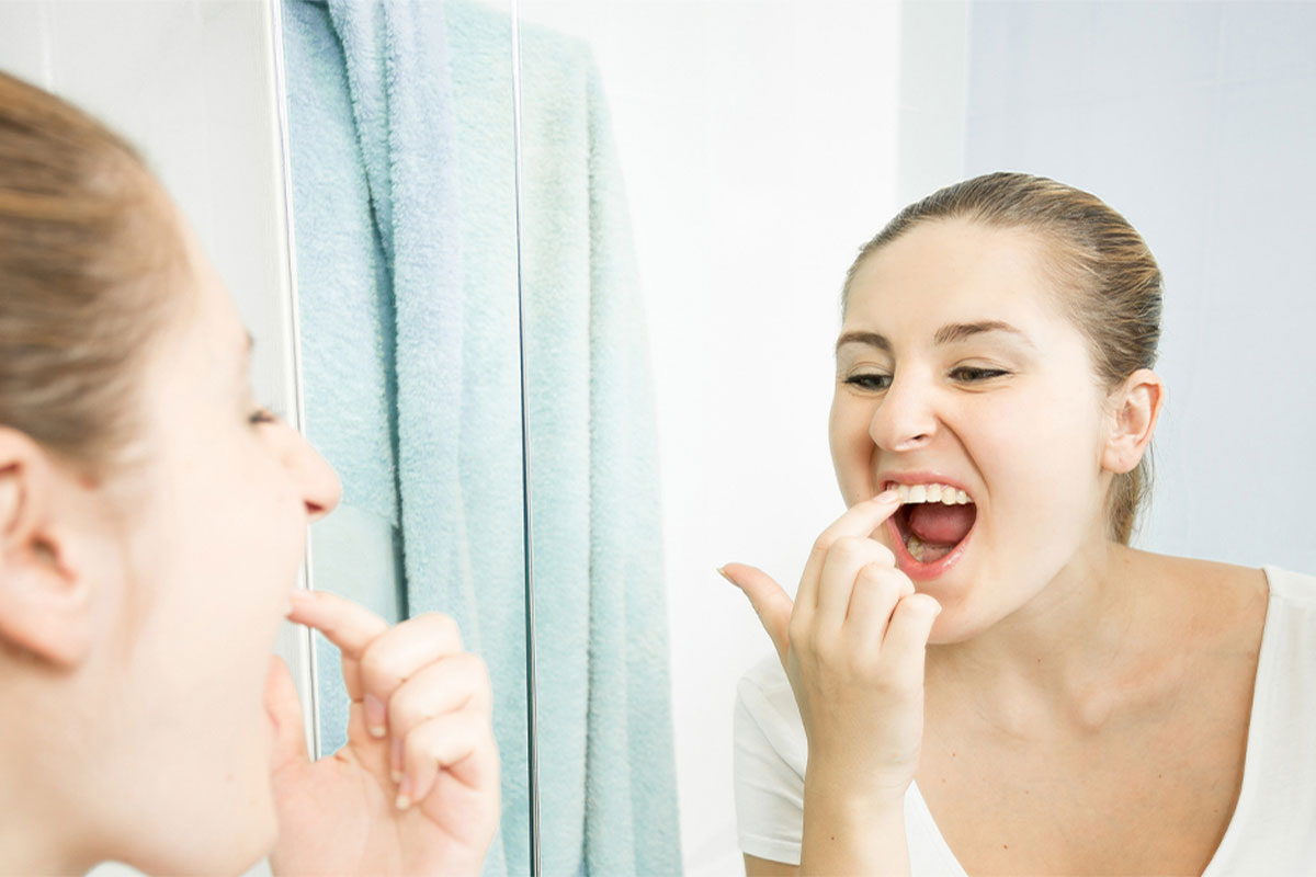 Beautiful woman check her teeth