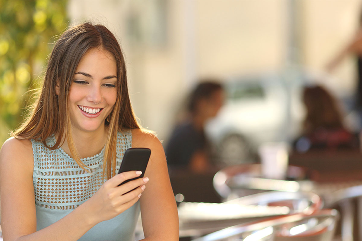 Beautiful woman smiling with her mobile