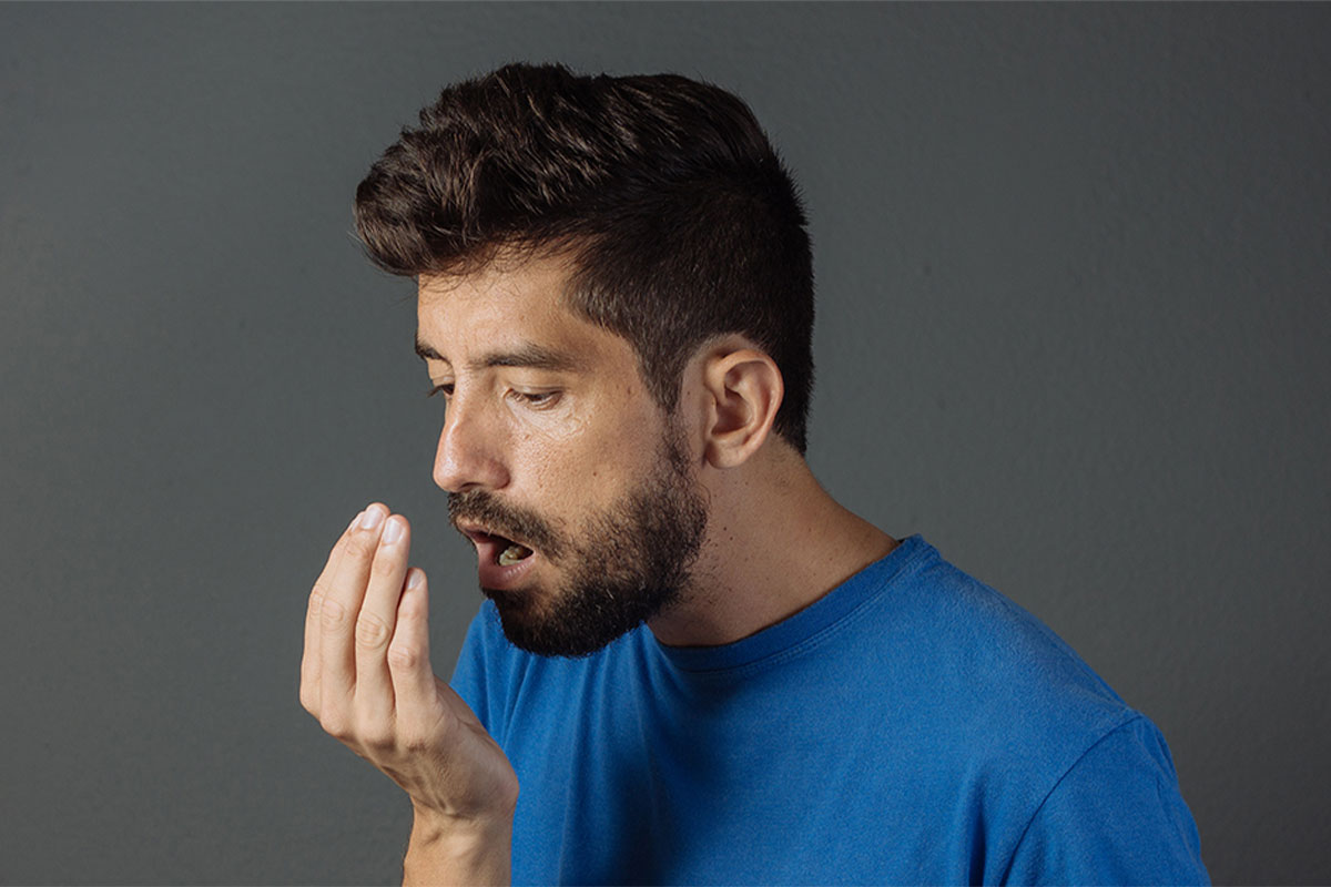 Person check his mouth smell